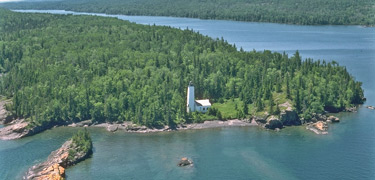 An aerial view of the Rock Harbor Lighthouse and channel.