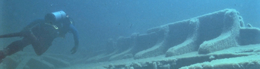 Scuba diver explores the rigs of a wreck.