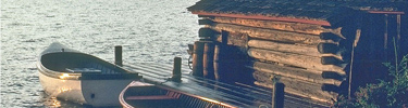 Fish house at Edisen Fishery is depicted with two boats at dock.