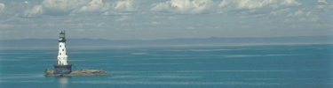 Aerail view of the Rock of Ages Lighthouse on a sunny day.
