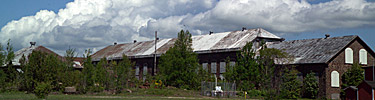Summer clouds drift over the now quiet buildings of the once mighty Calumet & Hecla Copper Mining Company. NPS Photo, Dan Johnson