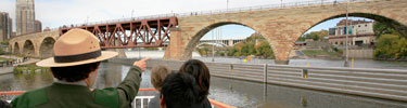 Ranger with children on the Minneapolis Queen during a Journey to the Falls educational trip.