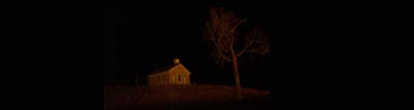 Lower Fox Creek School lit by the light of a prairie fire