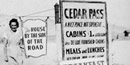 Historic photo of an employee and the Cedar Pass Camp sign