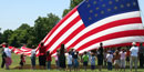 Children and families helping to raise the garrison flag on Flag Day 2006