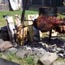 Fish and beef cooking over an outdoor kitchen fire.