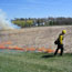 A firefighter sets a prescribed fire in the tallgrass prairie.