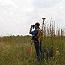 An NPS ornithologist from the Heartland Network monitors grassland birds in a national park.