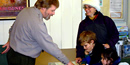 picture of visitors asking a park ranger a question over a counter