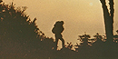 A sunset silhouette of a backpacker on a ridge. A sunset silhouette of a backpacker on a ridge.