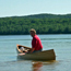 Visitor paddles a canoe on Beaver Lake.