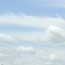White wispy clouds against a light blue sky White wispy clouds against a light blue sky