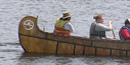 Park volunteer, Ida Mainville steers a canoe full of modern-day voyageurs.