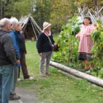 Visitors talk with historic gardeners at the Three Sisters Garden.