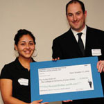 A man presents an award to a female high school student.