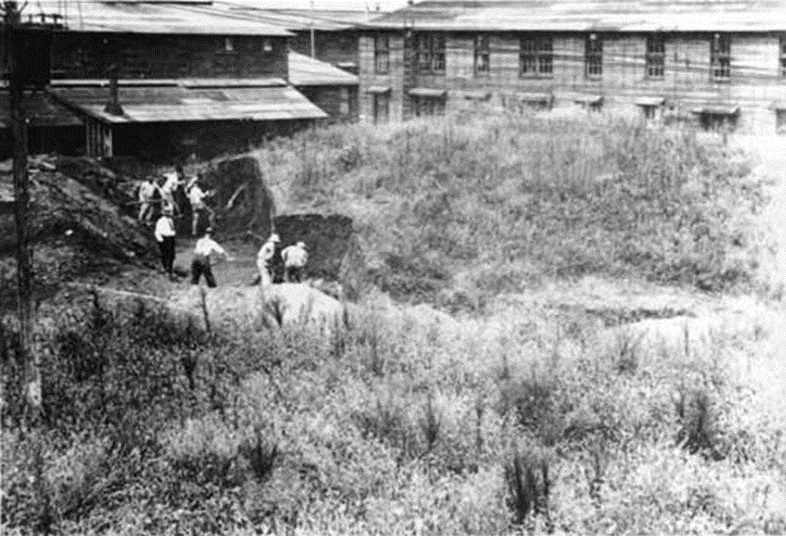 Camp Sherman barracks in background. Mounds being excavated in foreground. Camp Sherman barracks in background. Mounds being excavated in foreground.