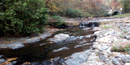 Gulpha Creek in fall, below campground amphitheater, with bridge over Gorge Road in right background Gulpha Creek in fall, below campground amphitheater, with bridge over Gorge Road in right background