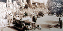 Pres. Roosevelt is in an open touring car on Fountain St. in front of the Arlington Hotel. A crowd surrounds the car. Pres. Roosevelt is in an open touring car on Fountain St. in front of the Arlington Hotel. A crowd surrounds the car.