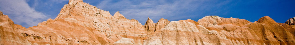 Badlands formations against the blue sky; photo by Rikk Flohr