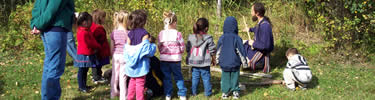 Grand Portage headstart learns how to harvest wild rice using rice knockers.