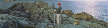 Rick Stevens working on a painting on an island in the Rock Harbor channel.