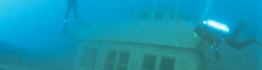 Scuba divers explore the pilot house of the Congdon.