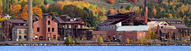 Autumn leaves provide a backdrop for the Quincy Smelting Works located along Portage Lake across from Houghton, Michigan. Autumn leaves provide a backdrop for the Quincy Smelting Works located along Portage Lake across from Houghton, Michigan.