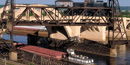 A barge going underneath a bridge. A barge going underneath a bridge.