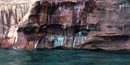 Mineral seepage creates the vibrant colors shown on this close-up photo of the Pictured Rocks cliffs. Mineral seepage creates the vibrant colors shown on this close-up photo of the Pictured Rocks cliffs.
