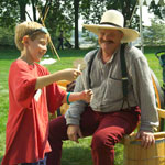 A boy playing with a historic toy