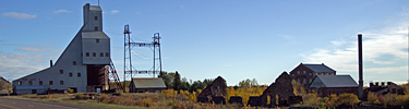 Ruins and remaining structures of the former Quincy Mine stand alongside U.S. Highway 41.