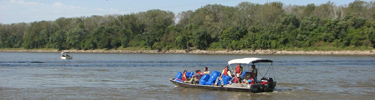 boat on the Missouri River bringing volunteers to pick up trash along the riverbanks