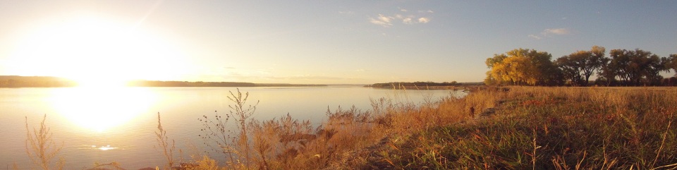 An explosion of light as the sun strikes the waters of the Missouri National Recreational River