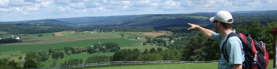 A hiker enjoys the view along the North Country Trail in New York.