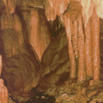 Stalactites decorate a cave scene.