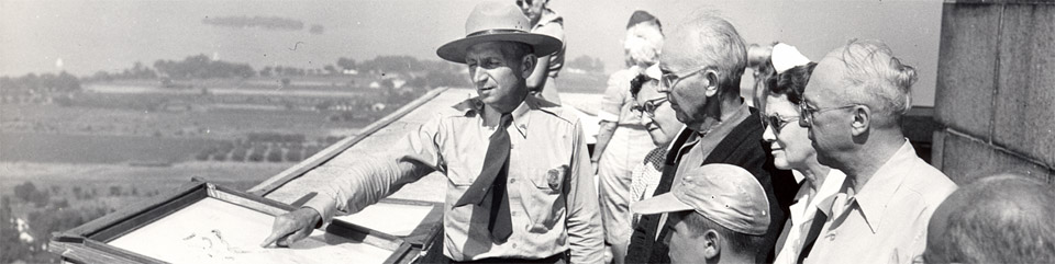 Old Time Park Ranger on the memorial with visitors.