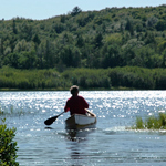 Visitor glides his canoe in the Beaver Basin Wilderness.