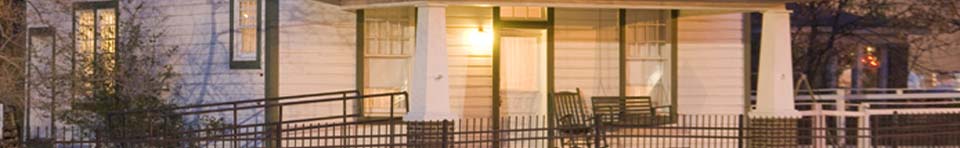 Image of the front porch of the Clinton Birthplace Home at night.