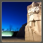 Marble statue of Martin Luther King Jr at night