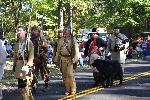 Re-enactors proceed to the grave site.