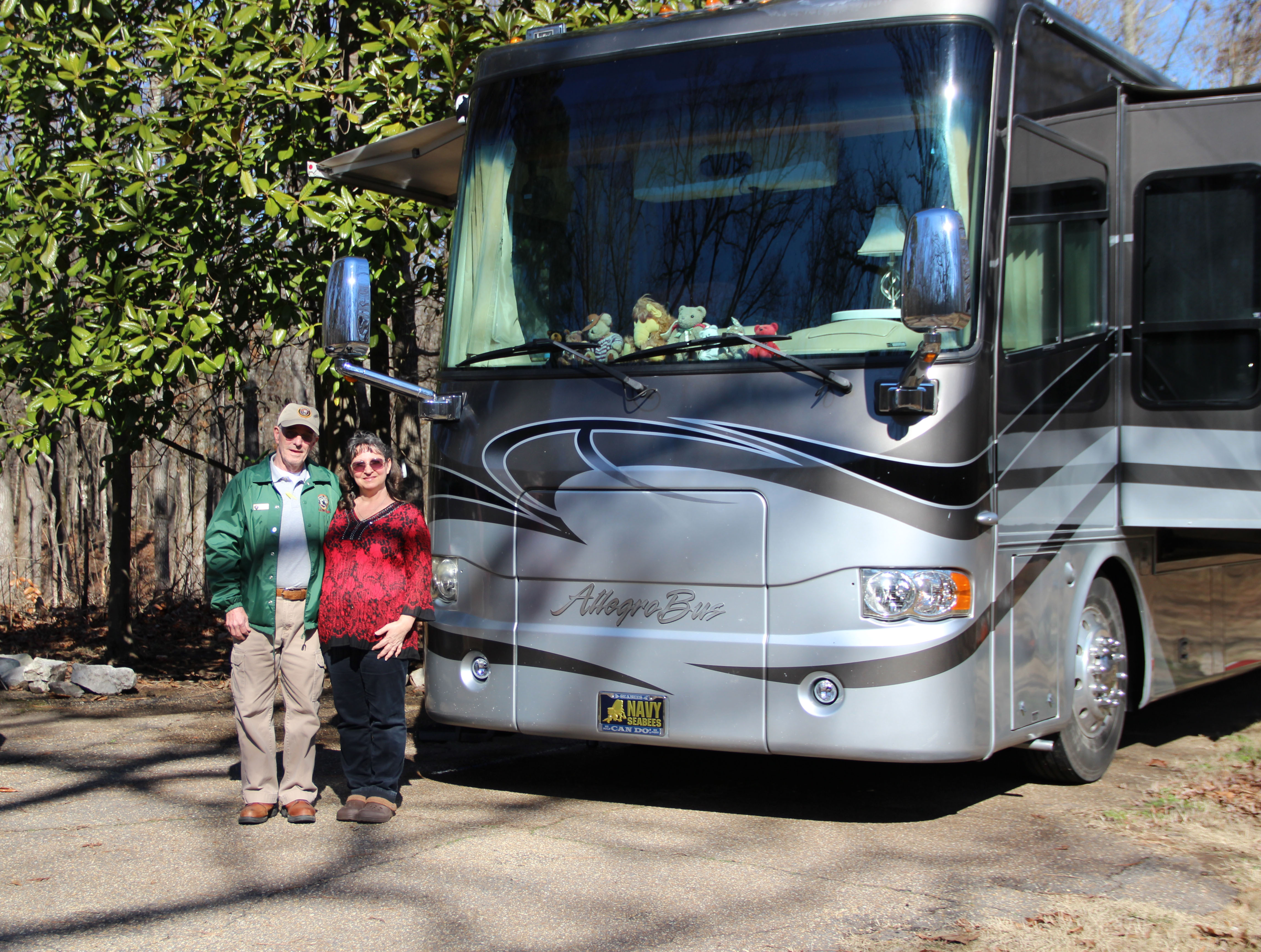 volunteer Denny Sims and his wife Lisa standing in front of a recreational vehicle