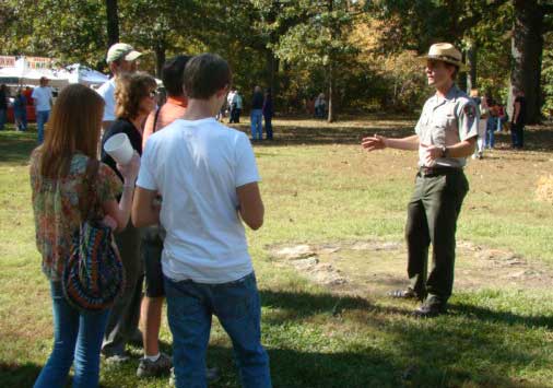 Visitors join a ranger for a scheduled talk.