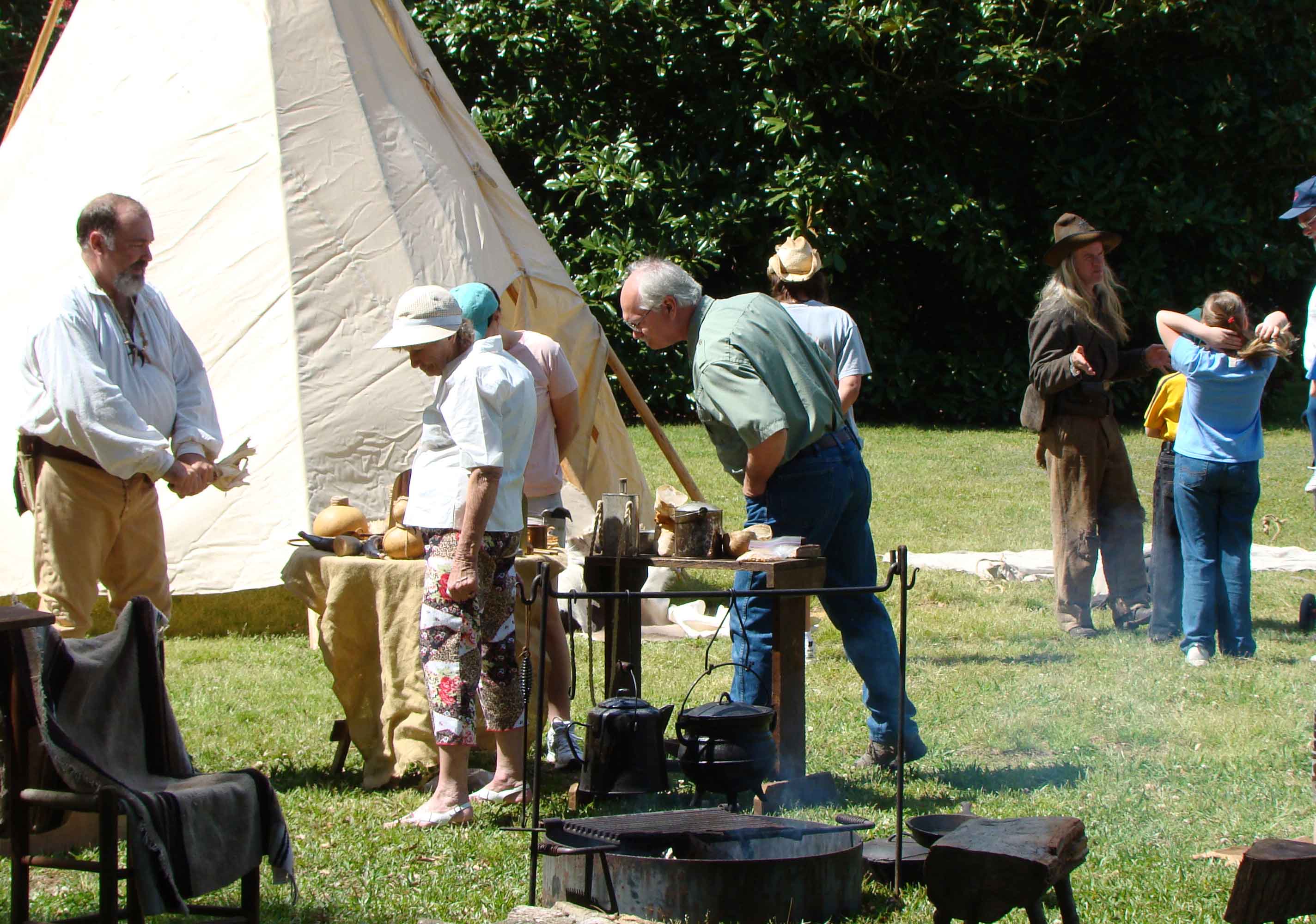 Visitors talk with members of the Tombigbee Pioneer Group at their encampment.
