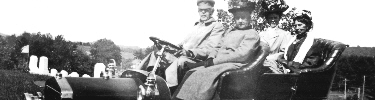 Clara Barton riding in the back seat of a car with her relatives in 1909