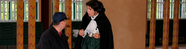 Clara Barton actress giving cup of water to actor dressed as Union soldier.