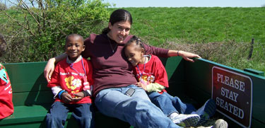 children with adult enjoying a wagon ride