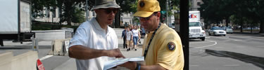 A park volunteer assisting the visitor. (NPS Photo by J. Feeney)