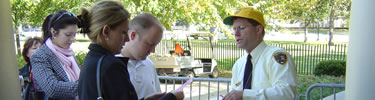 A park volunteer passing out tickets for White House Garden Tours. (NPS Photo by J. Feeney)