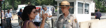 A park ranger assisting a visitor. (NPS Photo by J. Feeney)
