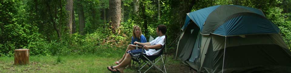 Campers relaxing at their site